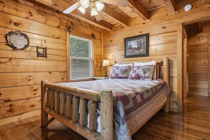 Picture yourself winding down in this cozy rustic bedroom, where warm wood and a handcrafted log bed invite peaceful mountain nights and restful mornings.