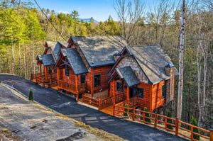 Stunning log cabin retreat nestled among vibrant spring foliage with mountain views and spacious parking for your mountain getaway.