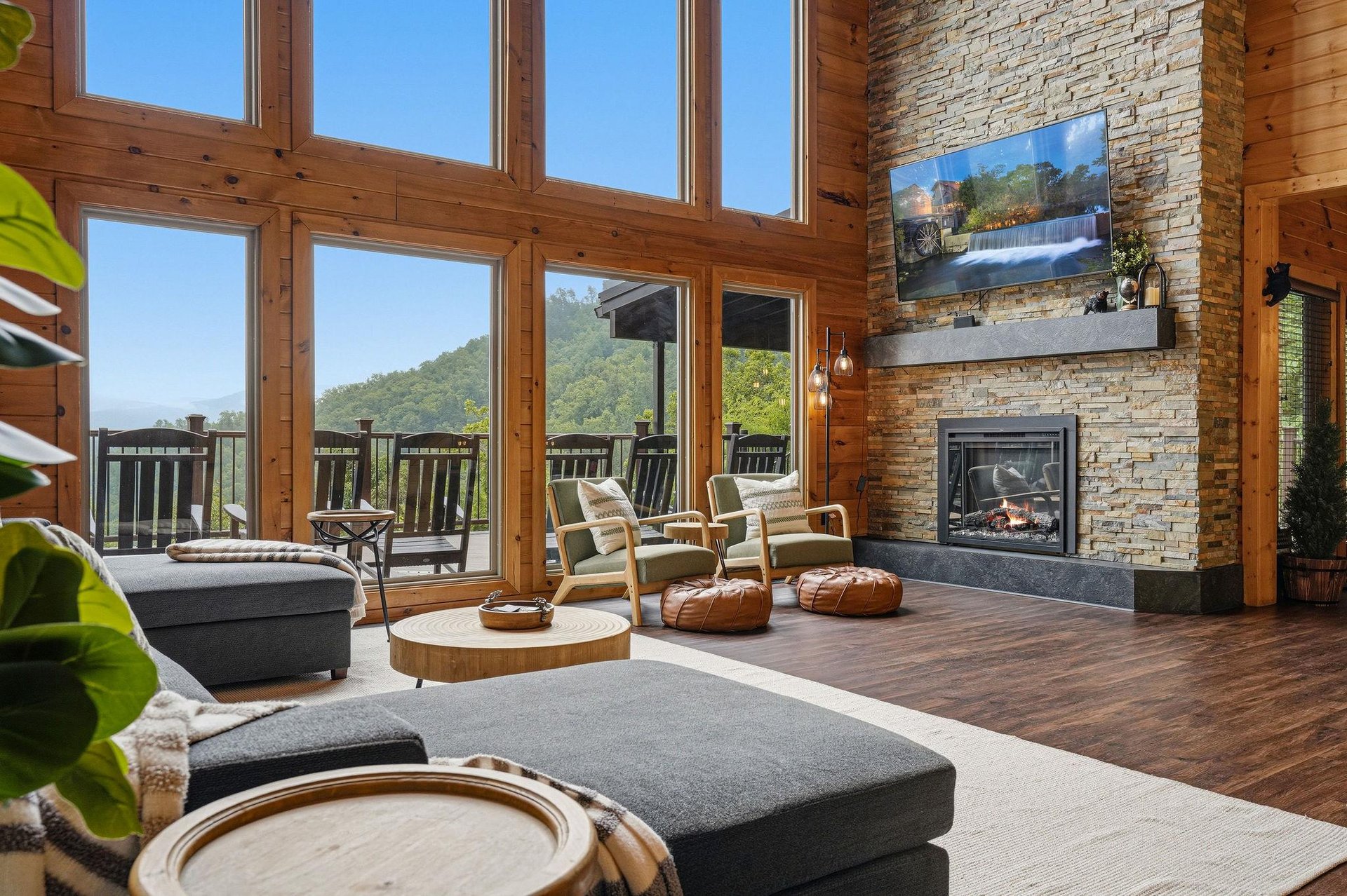 Sink into plush seating beside your stone fireplace and soak in sweeping mountain views through soaring windows—your perfect retreat for peaceful mornings and cozy evenings.