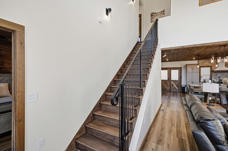 Warm wood floors and rustic beams create a cozy atmosphere as you move between your spacious living areas and private retreats.