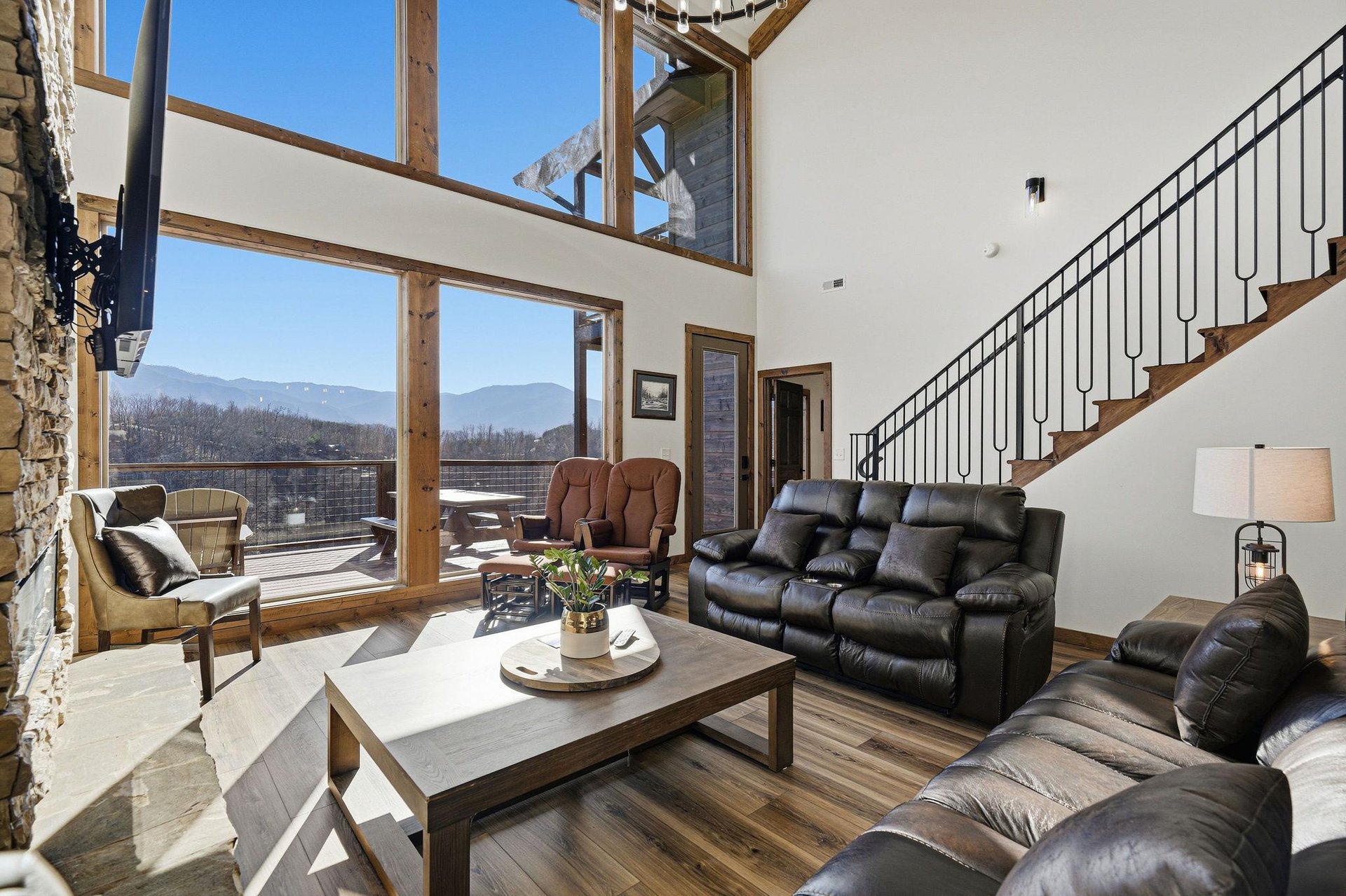 Relax in your spacious living room where floortoceiling windows frame breathtaking mountain views and natural light fills the space.