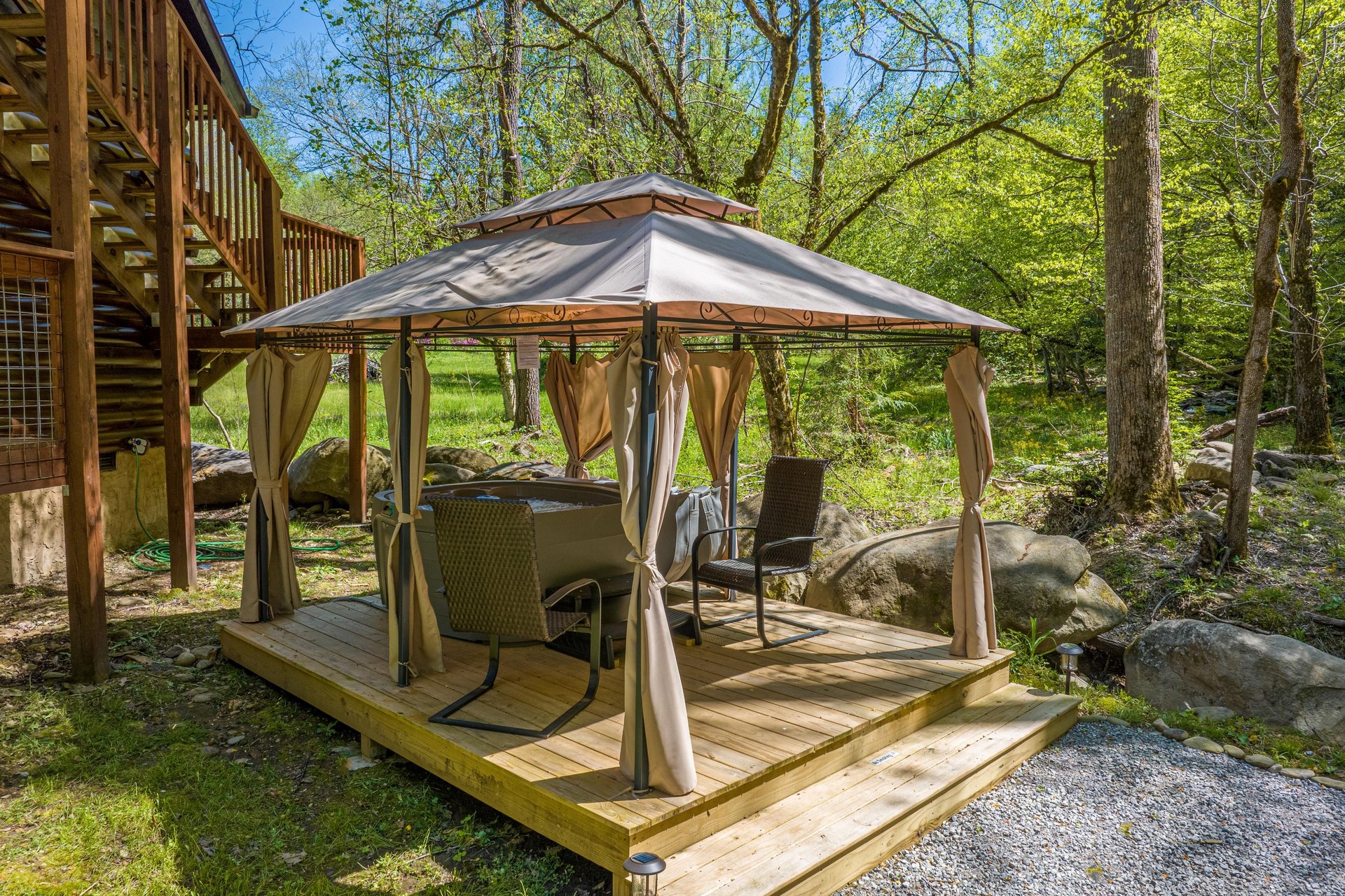 Hot tub and chairs under gazebo