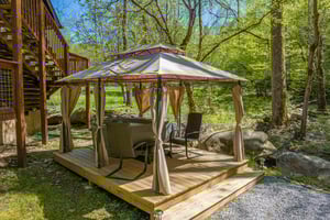 Hot tub and chairs under gazebo