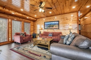 Sink into plush leather seating surrounded by warm wood walls and mountain views through expansive windows.