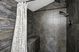 Unwind in your private spalike shower with stunning stone walls, natural textures, and modern fixtures creating pure relaxation.