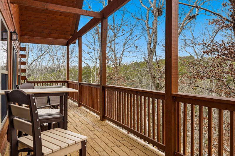 Your private covered terrace invites morning coffee moments, with natural wood details framing peaceful forest views that change with each season.