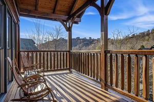 Stunning mountain vistas frame this private covered balcony, where you can rock gently in wooden chairs while soaking in panoramic valley views and crisp alpine air.