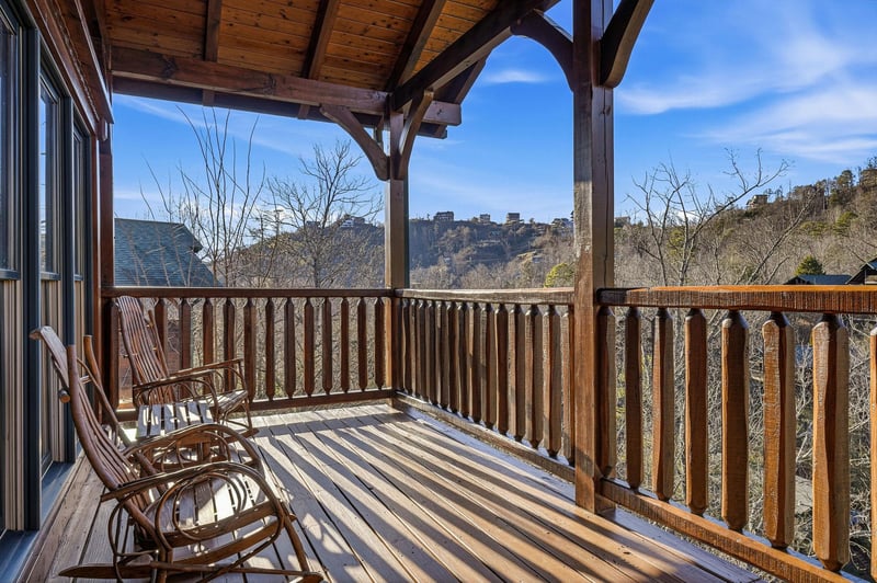 Stunning mountain vistas frame this private covered balcony, where you can rock gently in wooden chairs while soaking in panoramic valley views and crisp alpine air.