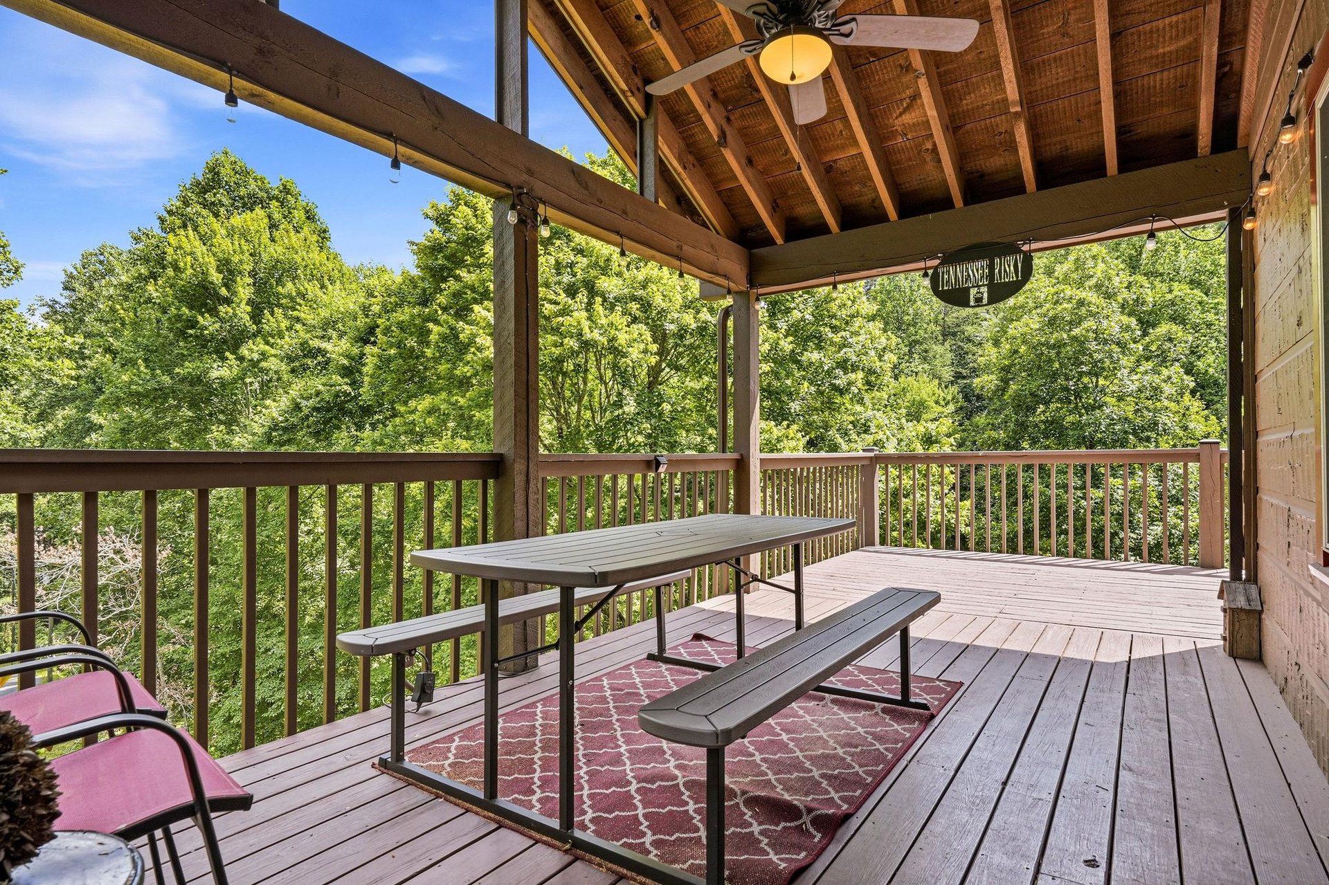 Imagine mornings here fresh mountain air, forest views, and your coffee at this covered deck. The ceiling fan keeps you cool, and the picnic table invites easy meals outdoors.