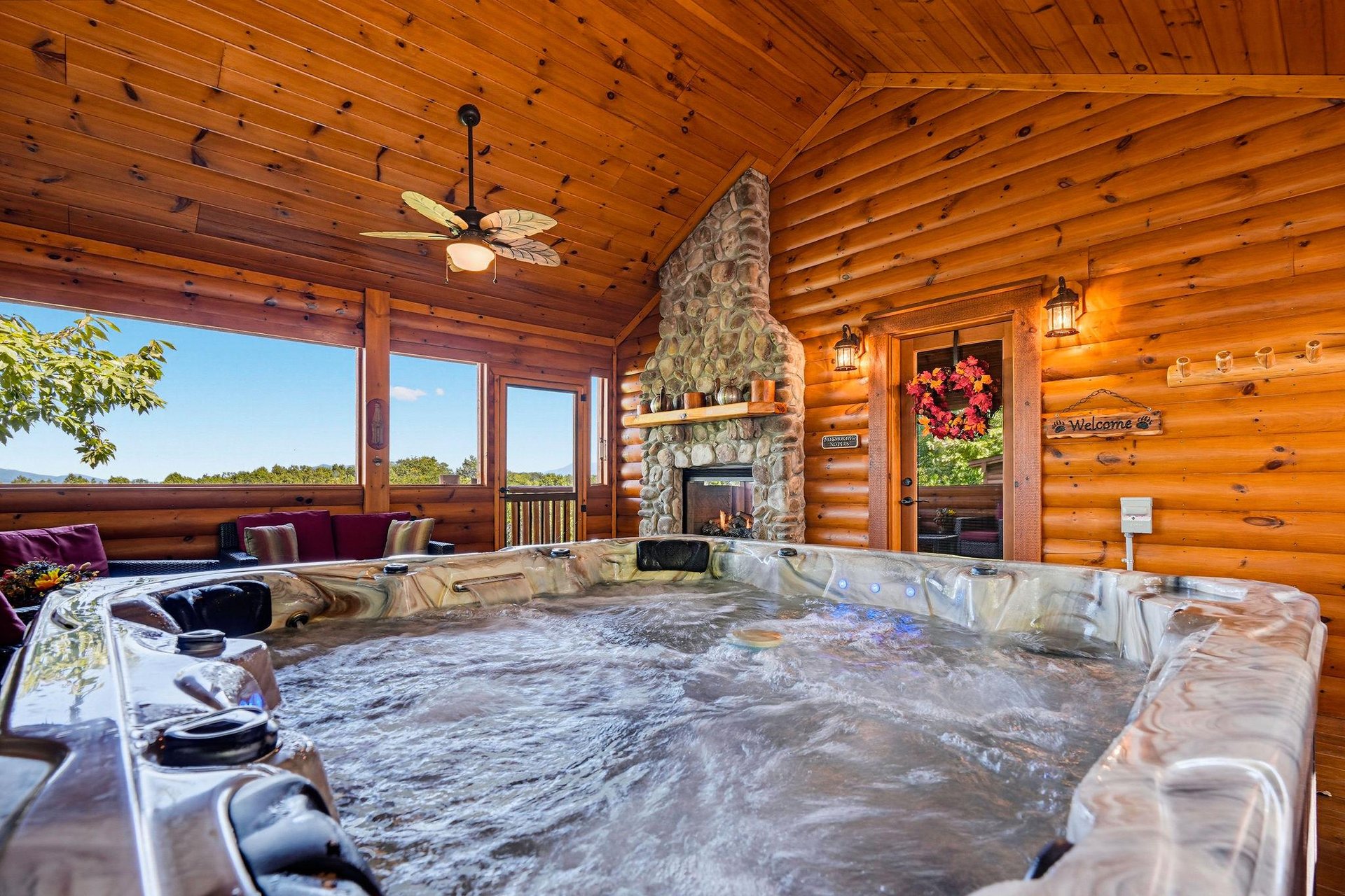 Soak in your private hot tub under the soaring wood ceiling, warmed by a stone fireplace and wrapped in peaceful mountain and forest views.