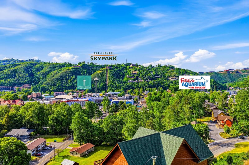 An aerial view of Gatlinburg showcasing the lush Smoky Mountains, nearby landmarks including SkyPark and Ripleys Aquarium, and the scenic neighborhood surrounding the property.