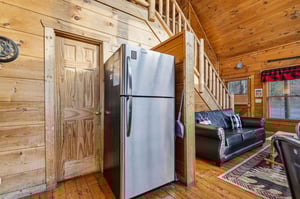 Cozy up in this rustic cabin where warm wood surrounds you, modern appliances meet mountain charm, and leather seating invites relaxation.