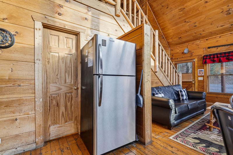 Cozy up in this rustic cabin where warm wood surrounds you, modern appliances meet mountain charm, and leather seating invites relaxation.