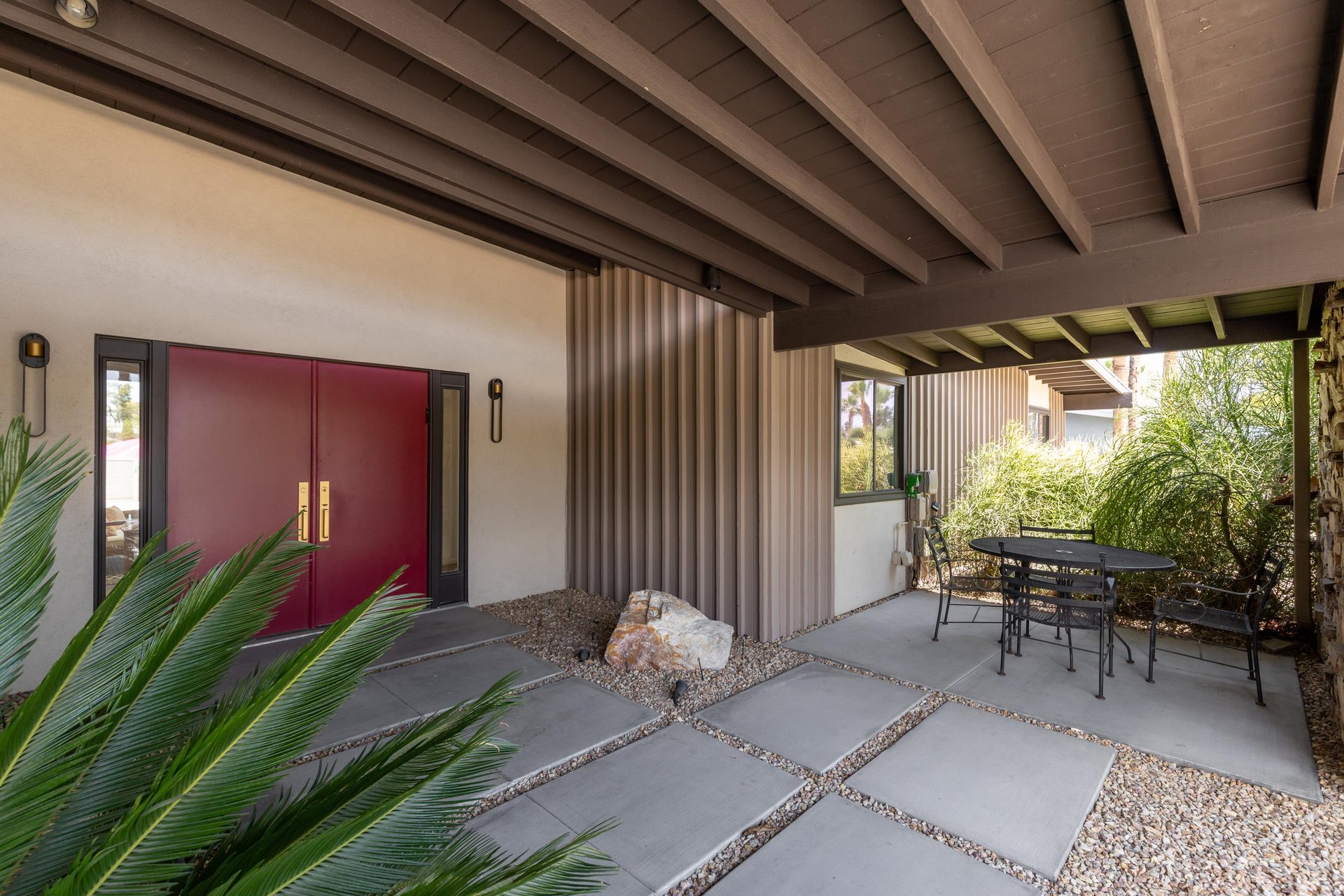 View of front entrway to the home along with additional outdoor seating for morning coffee.