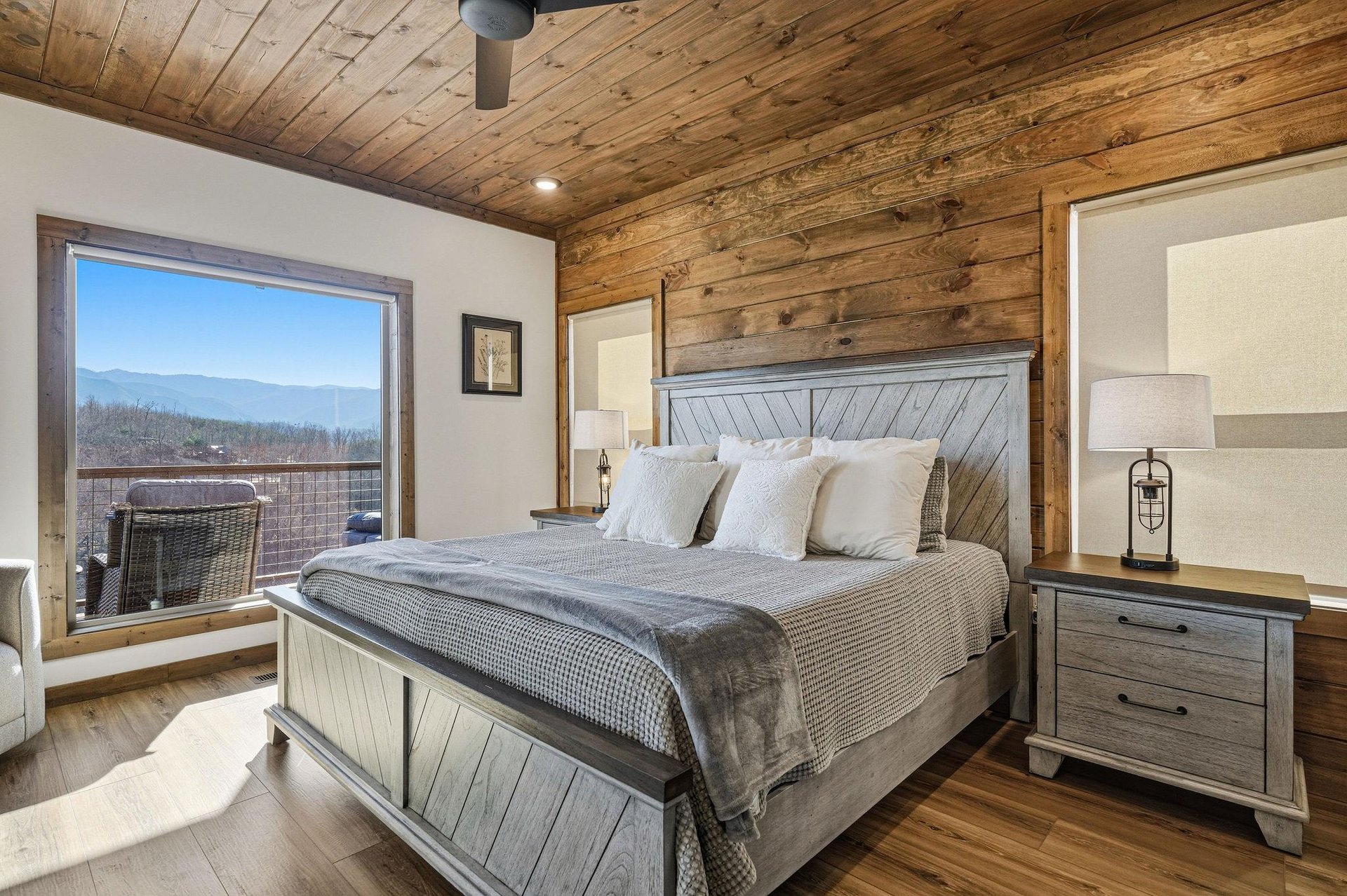 Wake up to breathtaking mountain views from your cozy rustic bedroom, where reclaimed wood meets modern comfort.