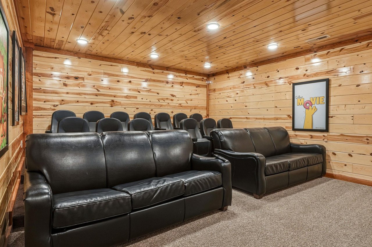Your private theater room awaits with plush leather seating and rustic wood walls, perfect for cozy movie nights with the whole group.