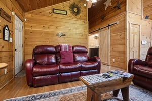Sink into plush leather recliners surrounded by warm pine walls and rustic charm. Your perfect mountain retreat awaits with cozy seating and homey touches throughout.
