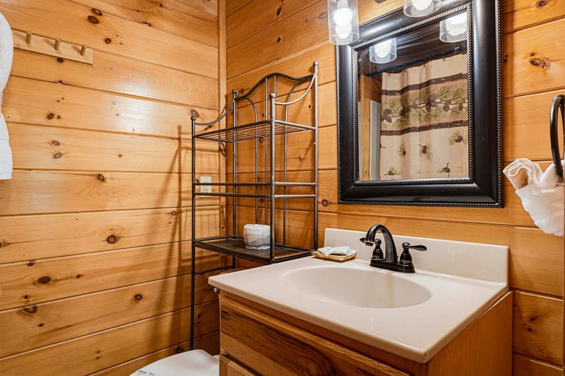 Warm wooden walls surround your private bathroom, featuring everything you need to freshen up in rustic comfort.