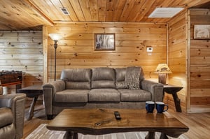 Sink into plush seating surrounded by warm knotty pine walls that create your perfect mountain retreat atmosphere.