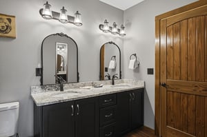 Step into your private spa retreat with dual vanities, elegant granite countertops, and warm wood tones that create a serene start to your day.