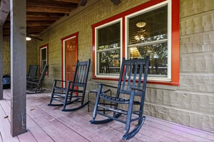 Picture yourself rocking gently on this covered porch, coffee in hand, taking in the peaceful morning air. Classic charm meets relaxation with inviting seating for unwinding after your days adventure