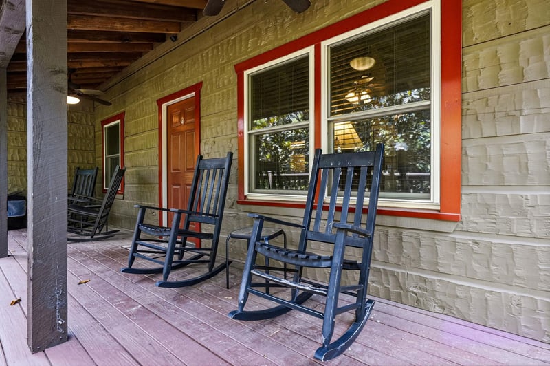 Picture yourself rocking gently on this covered porch, coffee in hand, taking in the peaceful morning air. Classic charm meets relaxation with inviting seating for unwinding after your days adventure
