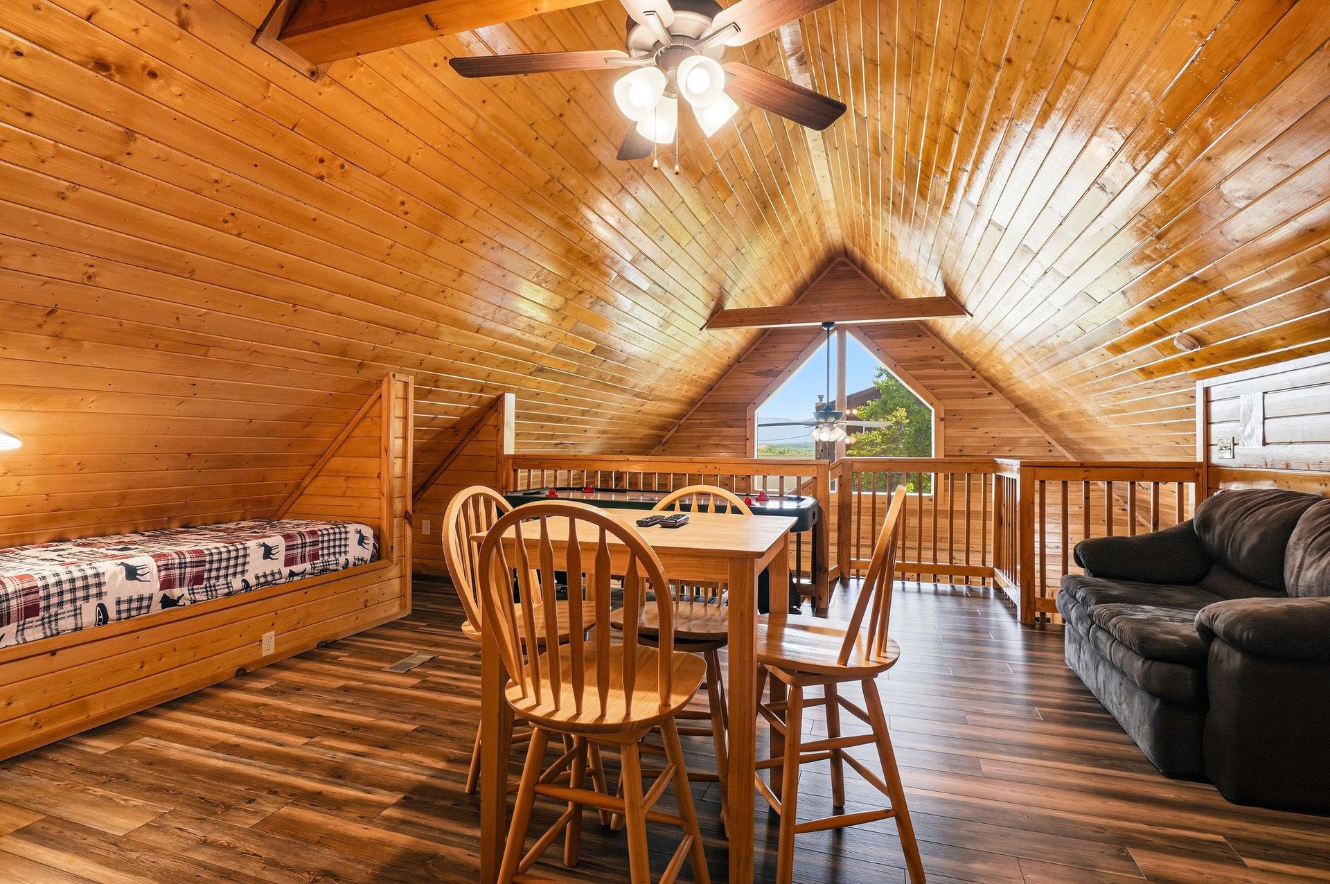 Your cozy loft retreat blends rustic charm with comfortable living. Warm wood beams embrace a welcoming space where youll gather for games, relax on the sofa, or drift off in twin beds under vaulted 