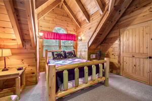 Bedroom with a log bed and futon at Alpine Sondance, a 2 bedroom cabin rental located in Pigeon Forge