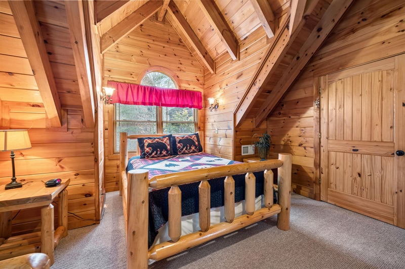 Bedroom with a log bed and futon at Alpine Sondance, a 2 bedroom cabin rental located in Pigeon Forge