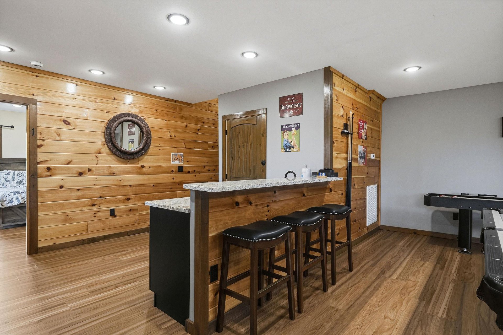 Your private bar area features warm wood paneling and granite countertop seating—perfect for evening gatherings or casual conversations over drinks.