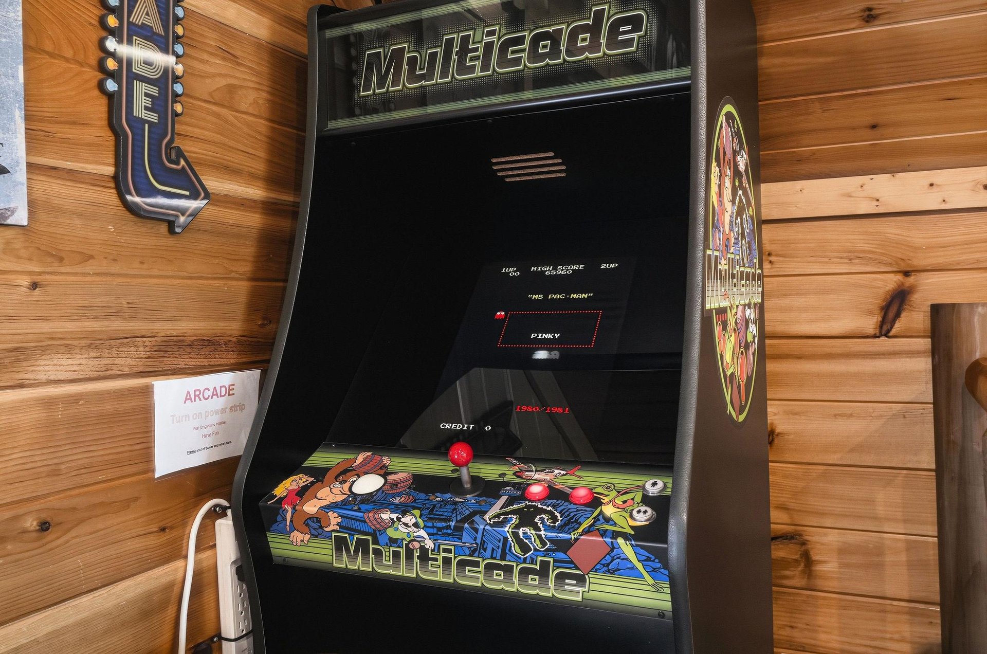 Challenge your friends to a classic arcade showdown on the vintage Multicade machine, featuring nostalgic games and vibrant retro décor in your cozy game room.