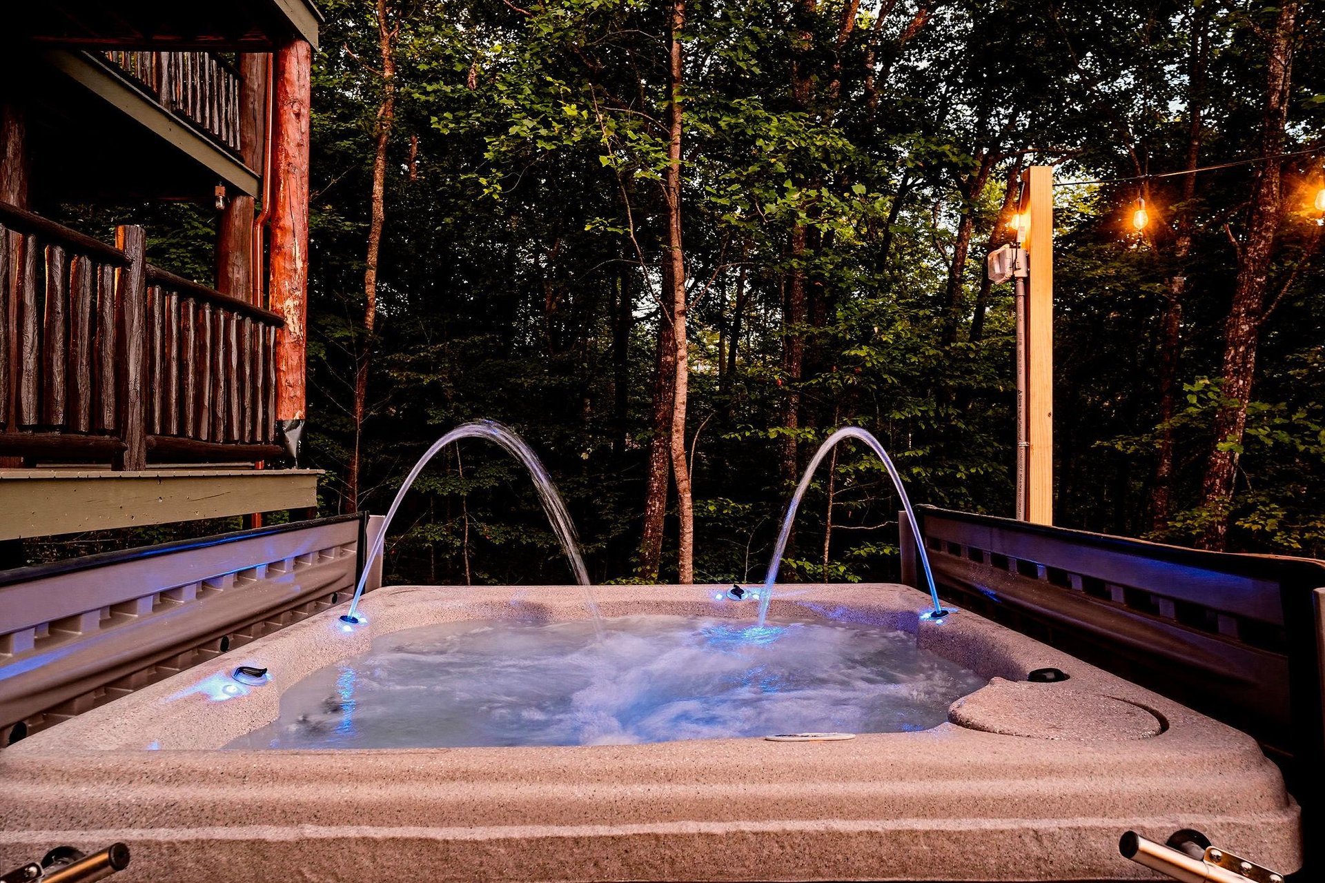 Unwind beneath the forest canopy in your private hot tub, where glowing evening lights and the gentle sounds of nature create the perfect sanctuary for relaxation.