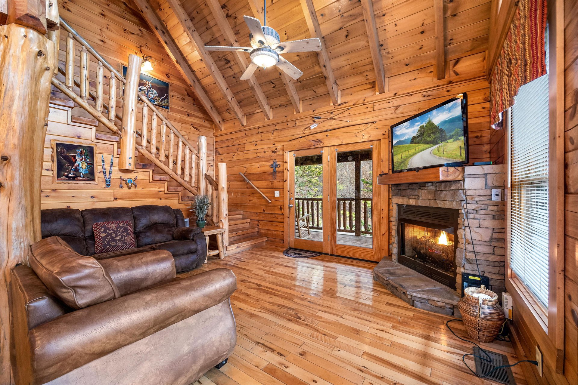 Living room with fireplace and TV at Alpine Sondance, a 2 bedroom cabin rental located in Pigeon Forge