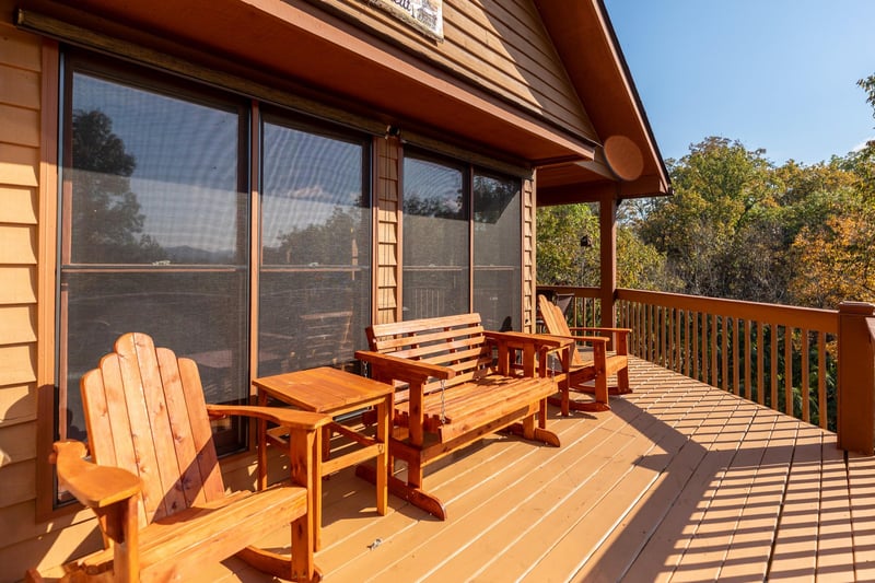 Adirondack rocker and loveseat glider on the open deck at Lazy Bear Retreat, a 4 bedroom cabin rental located in Pigeon Forge