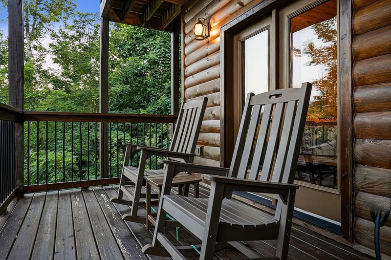 Step onto your private covered balcony and sink into a classic rocking chair, where lush forest views create your peaceful retreat in nature.