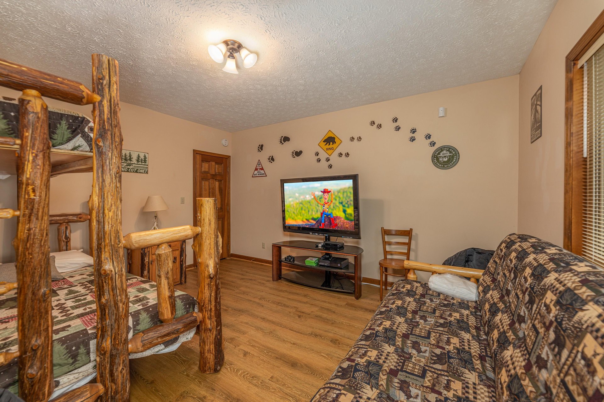Room with a bunk bed and futon at Cubs Crib, a 3 bedroom cabin rental located in Gatlinburg