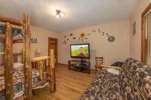 Room with a bunk bed and futon at Cubs Crib, a 3 bedroom cabin rental located in Gatlinburg