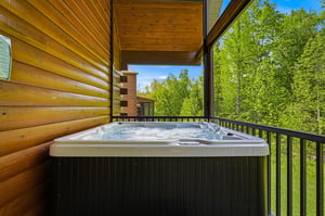 Slip into your private hot tub and let warm bubbles melt away stress as you breathe in fresh forest air and soak in lush treetop views from your covered balcony.