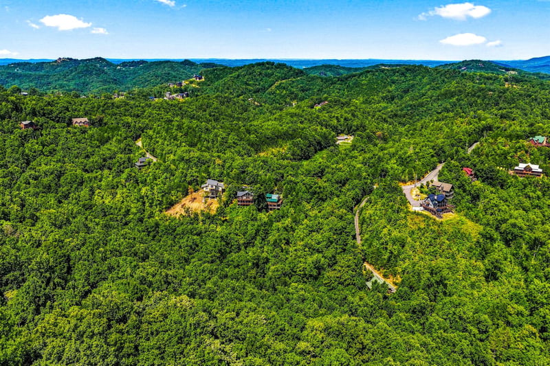 Nestled in lush rolling mountains, the property offers peaceful seclusion among forested hillsides and winding scenic roads in a serene natural setting.