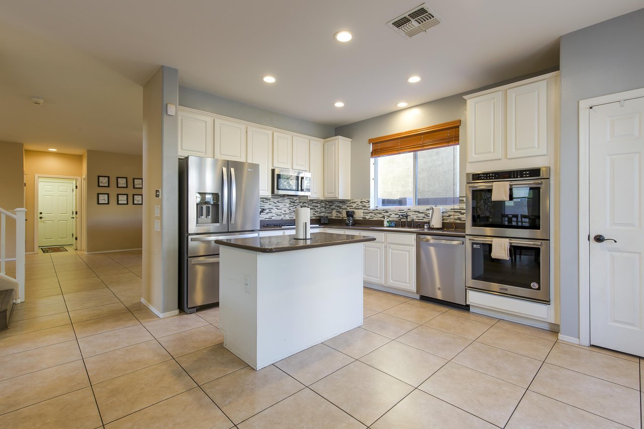 Stainless steel appliances, island counter, and cooking essentials.