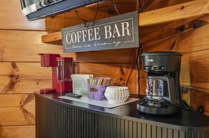 Start your mornings right at your own coffee bar, where everything you need to brew your perfect cup is ready and waiting beneath rustic wood beams.