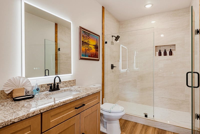 Step into your beautifully designed bathroom with warm wood accents, a walkin shower, and modern finishes that make every morning feel refreshing.