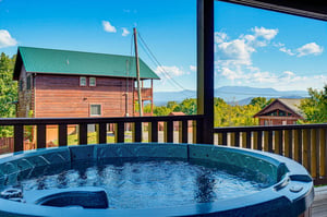 Soak in your private hot tub with sweeping mountain views stretching across the horizon—pure relaxation with nature as your backdrop.