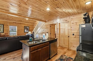 Unwind in your cozy cabins heart, where rustic wood surrounds create warmth while modern appliances ensure comfort for memorable meals.