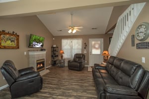 Living room with fireplace and TV at Peace at the River, a 3 bedroom cabin rental located in Pigeon Forge