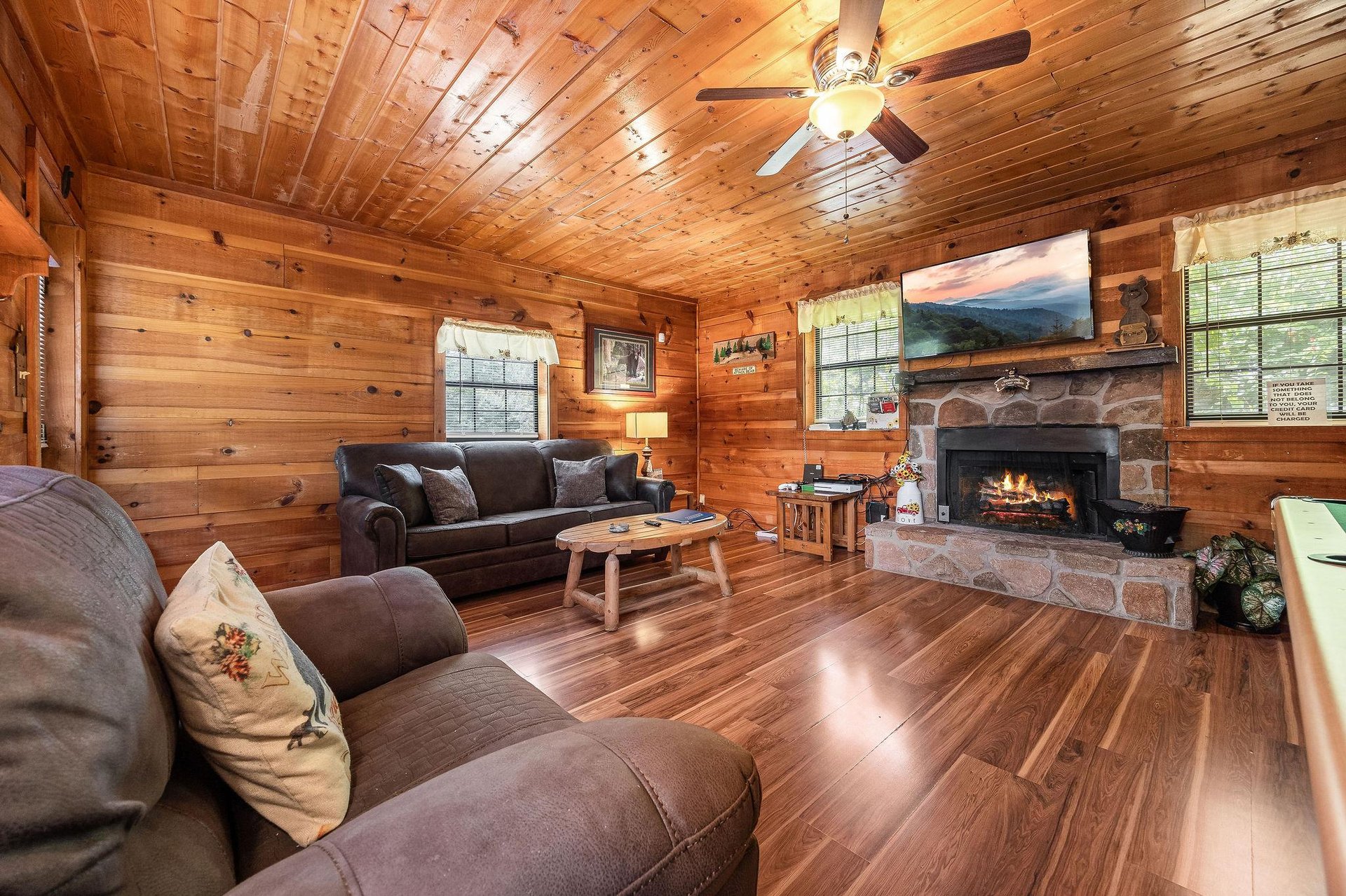 Living room with fireplace and TV at Beary Good Time, a 1bedroom cabin rental located in Pigeon Forge