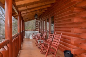Rocking chairs and hot tub on a covered deck