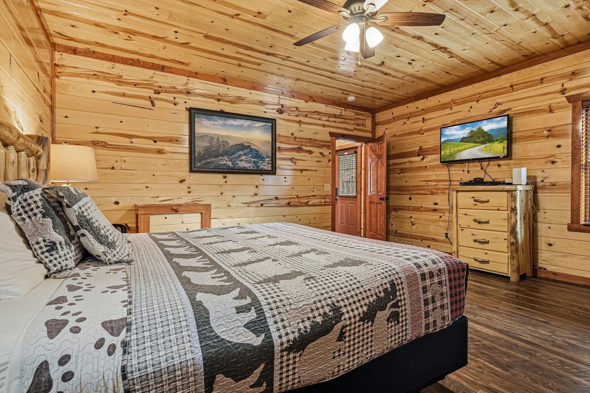 Unwind in this cozy log cabin bedroom where rustic charm meets modern comfort for your perfect mountain getaway.