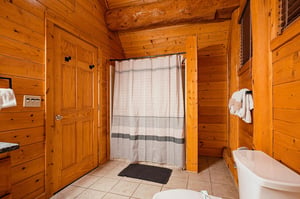 Warm wood paneling brings cabin charm to your private bathroom, complete with fluffy towels and everything you need to freshen up after a day exploring.