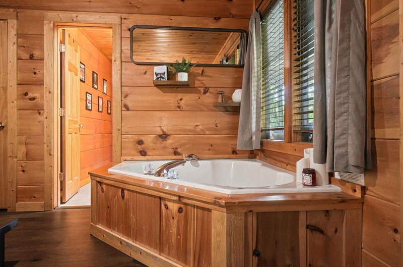 Slip into your private soaking tub surrounded by warm wood and natural light—a serene retreat where you can unwind after a day of adventure.